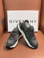 Dark gray lace-up sneakers with strap detail and white sole