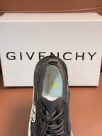 Dark gray sneaker with tongue logo in green and yellow