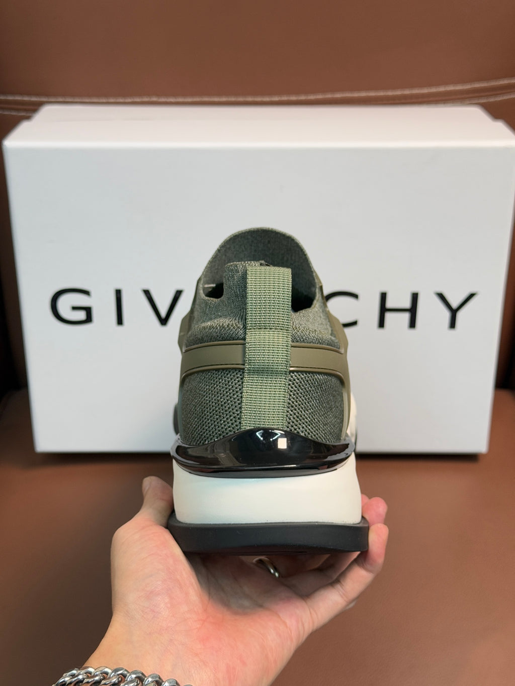 Givenchy sneaker heel view in olive green with dark heel panel
