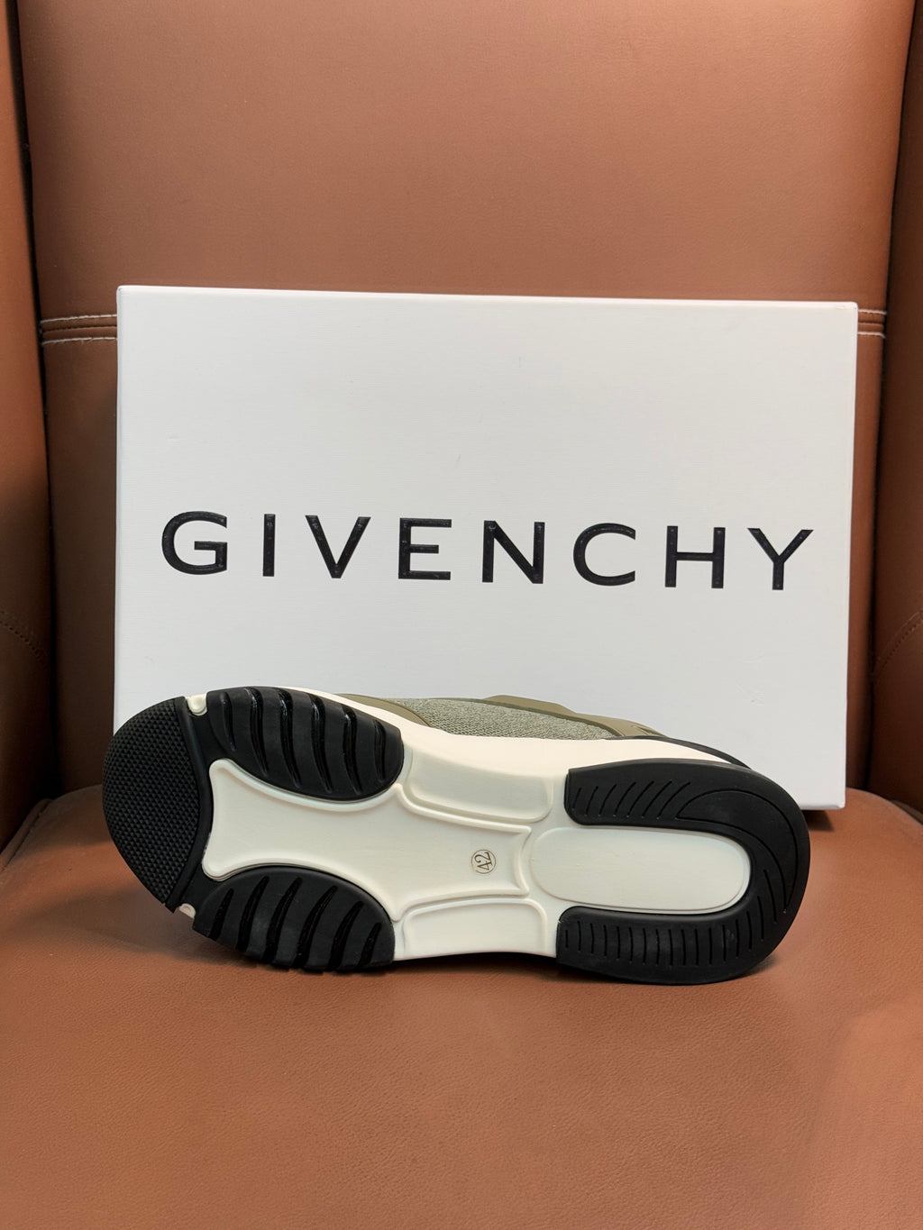 Givenchy sneaker outsole view with tread pattern and olive upper