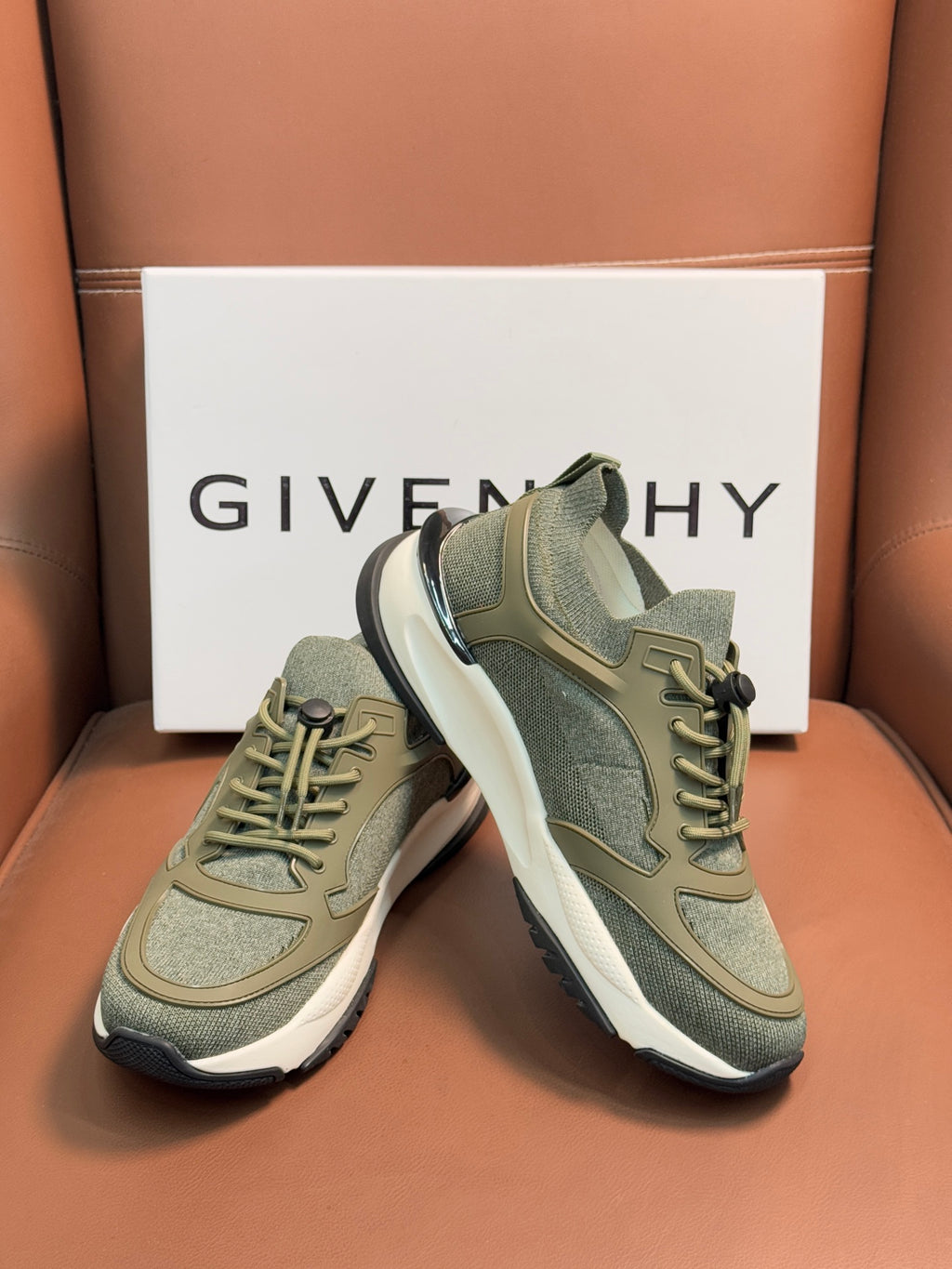 Givenchy sneakers shown from front, olive green uppers and white sole