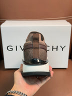 Brown Givenchy sneaker heel close-up with black rubber sole and lace eyelets
