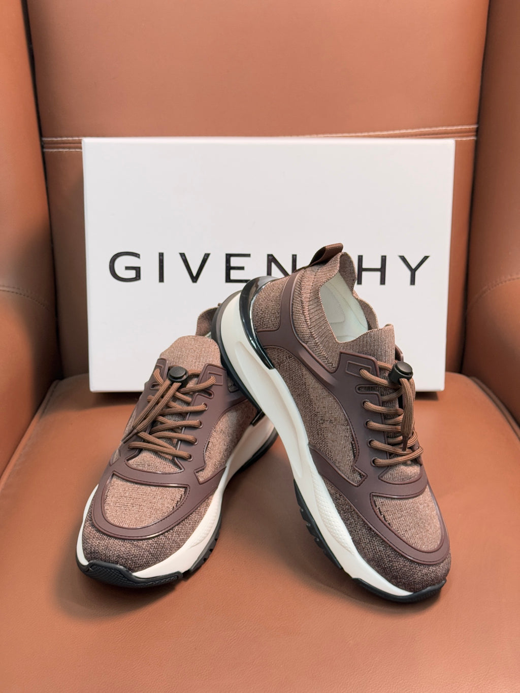 Brown Givenchy sneakers with lace-up, white sole and dark heel trim