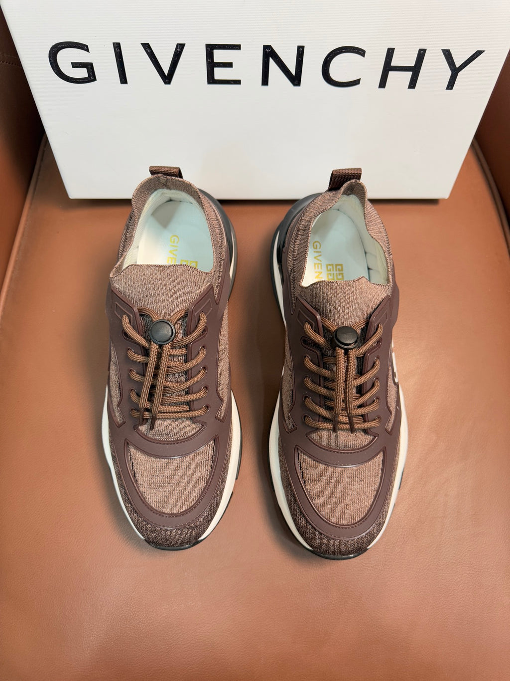 Pair of brown Givenchy sneakers with lace-up front and white rubber sole