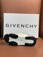White and dark rubber sneaker outsole with tread pattern.