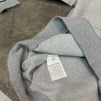 Grey hoodie inside label tag with ribbed cuff visible