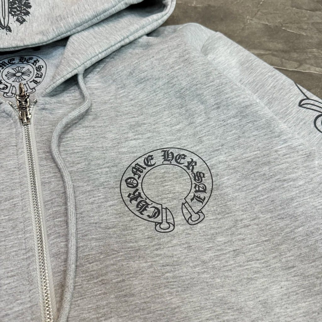 Grey hoodie close-up: zip front and circular logo graphic print