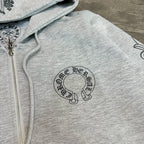 Grey hoodie close-up: zip front and circular logo graphic print