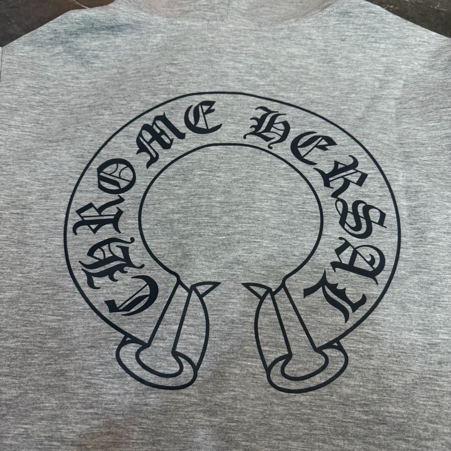 Grey hoodie back with large circular script graphic