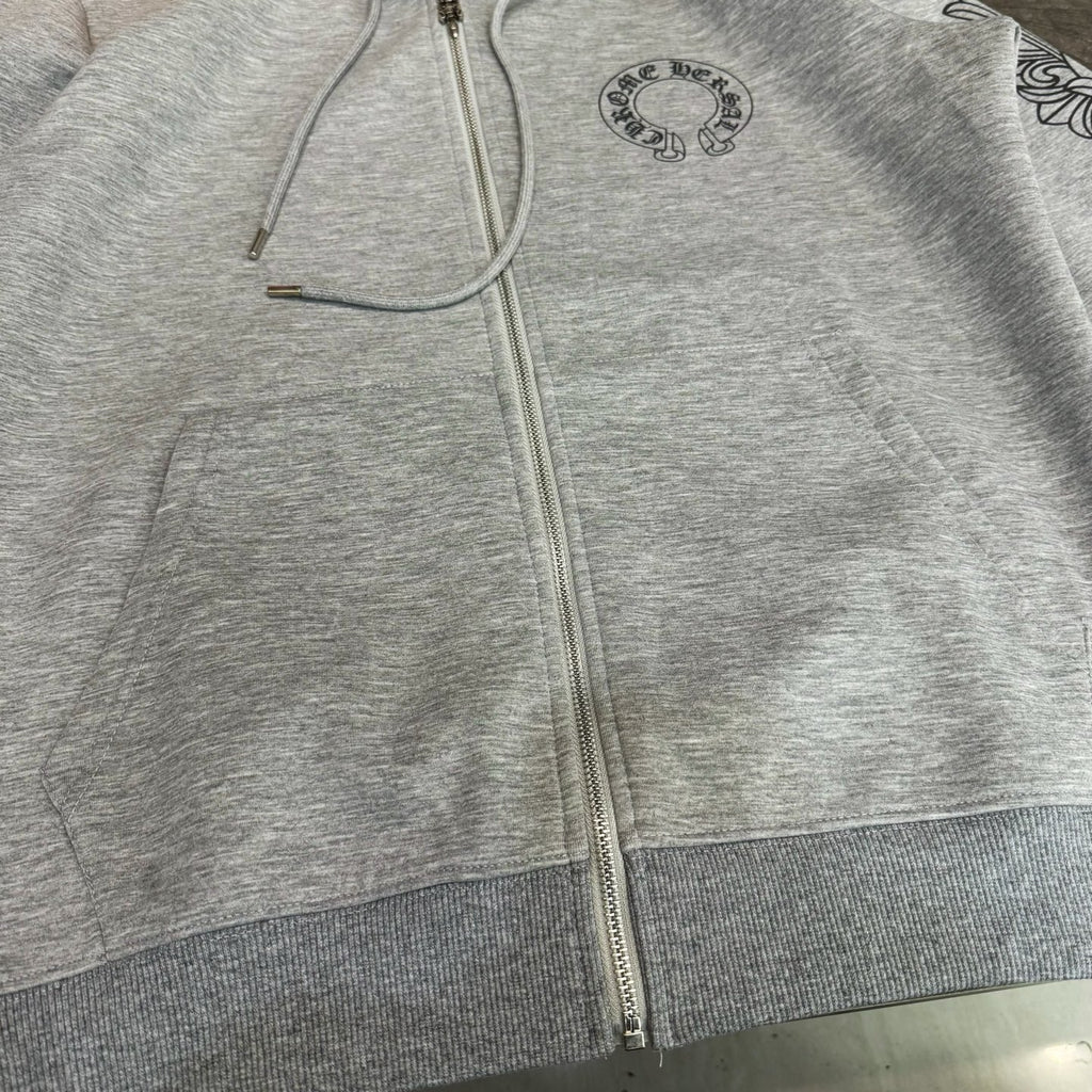 Grey zip-up hoodie front close-up with drawstrings and zipper