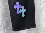 Black denim pants with purple and light blue cross patches on the leg
