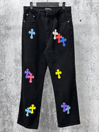 Black denim pants with colorful cross patches, front pockets and straight leg