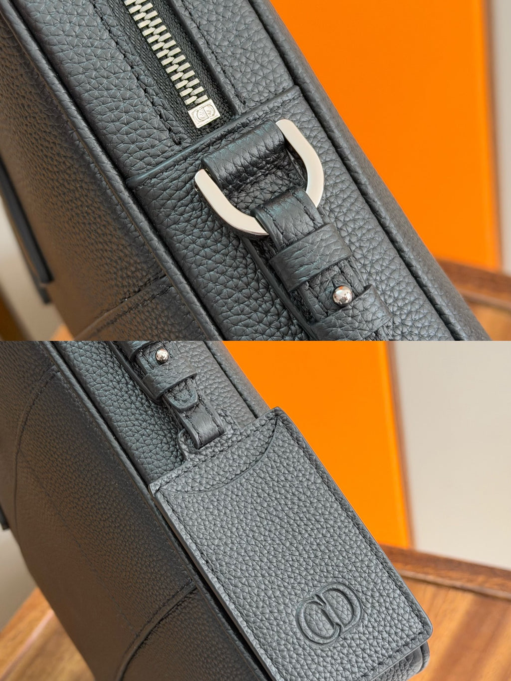 Close-up of zipper track and embossed logo on dark leather strap