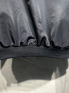Long hooded jacket hem close-up, dark gray with ribbed knit band