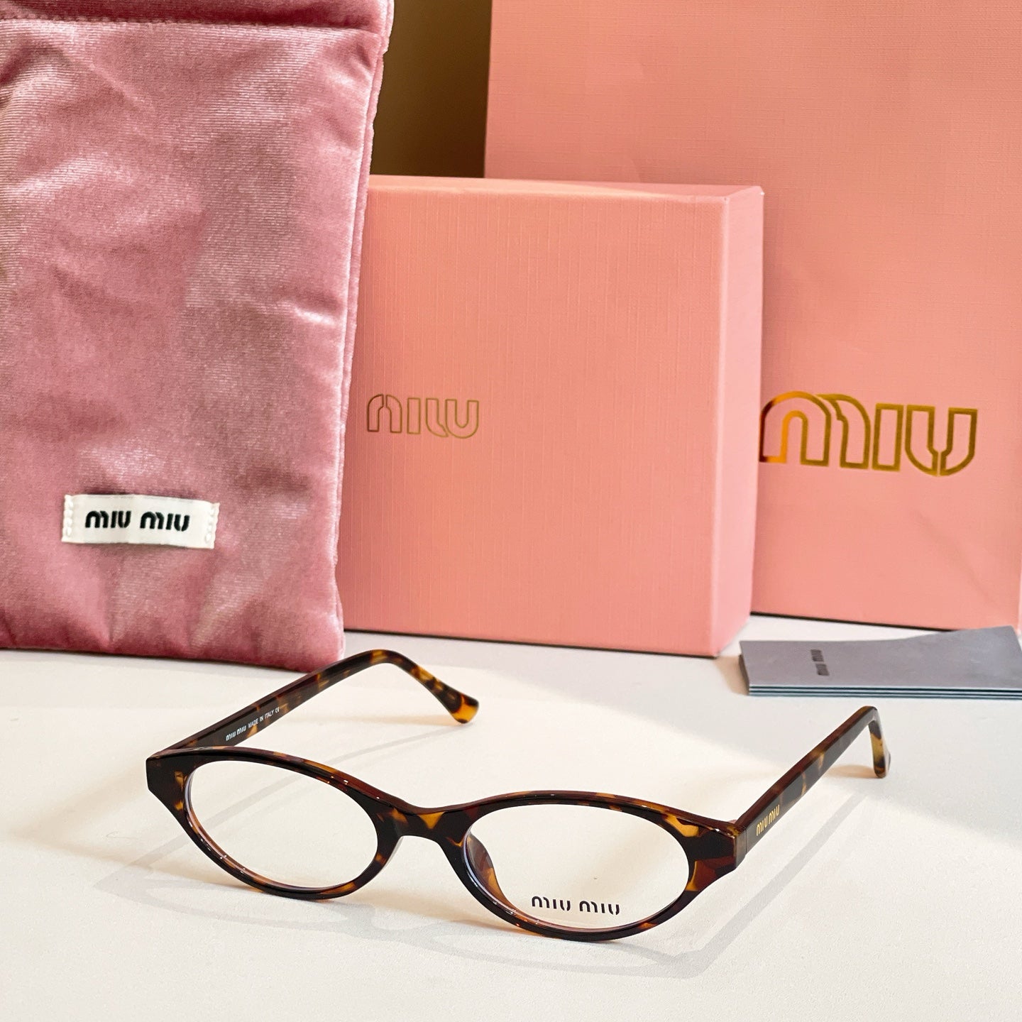 Miu Miu eyeglasses with tortoise acetate frames and round clear lenses