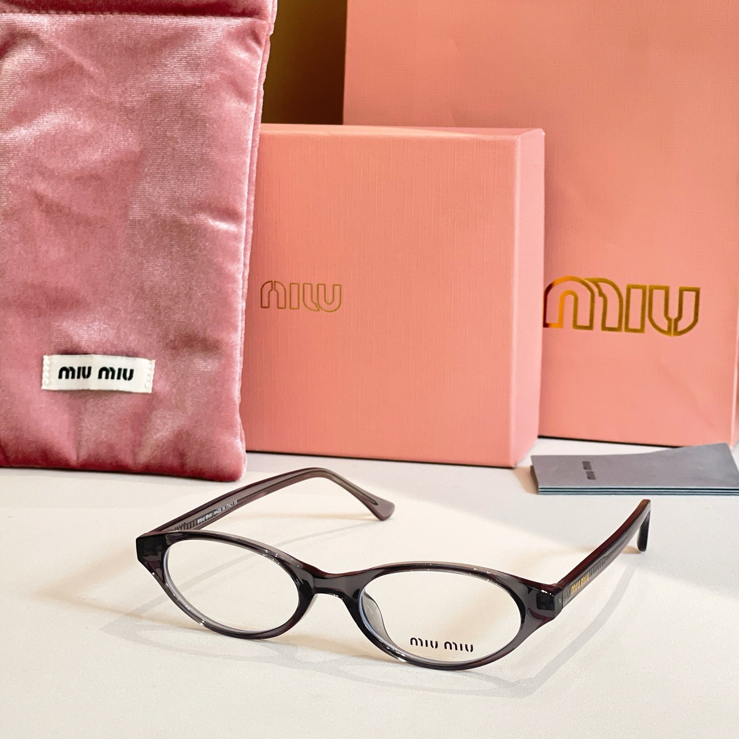 Miu Miu eyeglasses with dark frames and round clear lenses