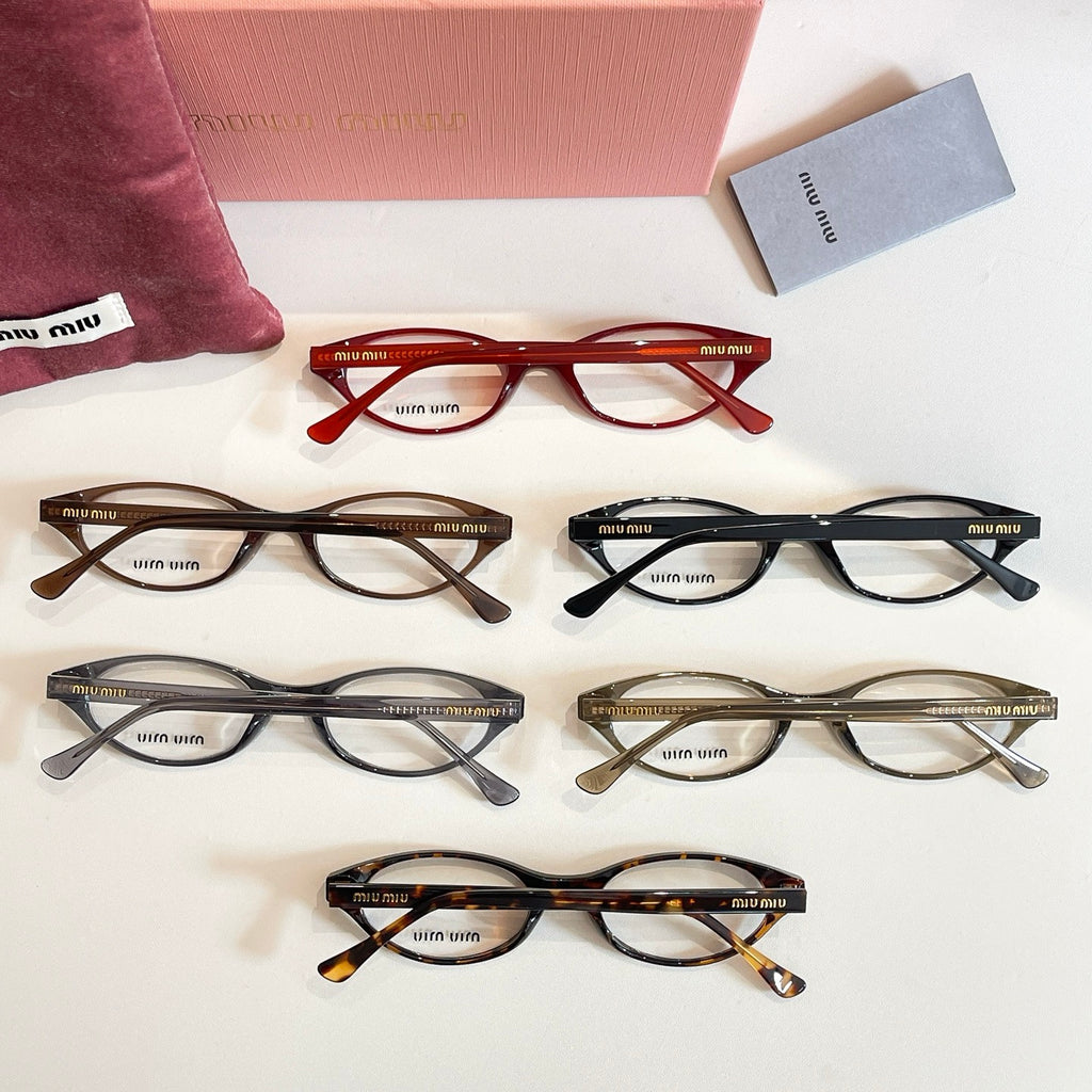 Assorted Miu Miu eyeglasses in red, black, and tortoise frames laid out on display