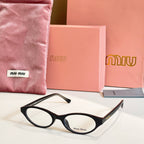 Miu Miu eyeglasses with black acetate frames and round clear lenses