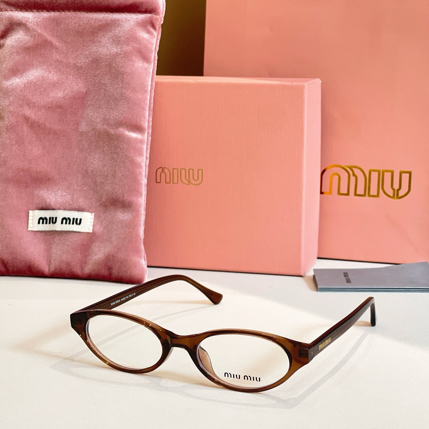 Miu Miu eyeglasses with brown tortoise acetate frames and round clear lenses