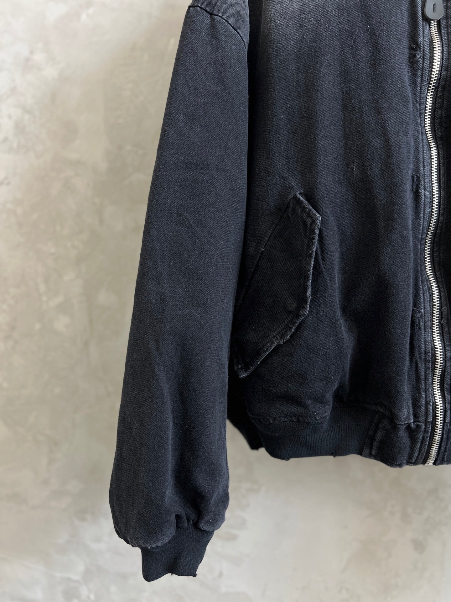 Dark zip-up jacket sleeve with zip front and patch pocket