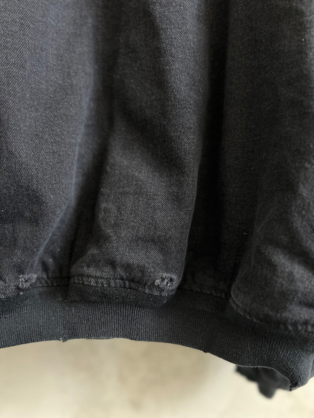 Balenciaga dark denim jacket hem with ribbed knit trim and stitching
