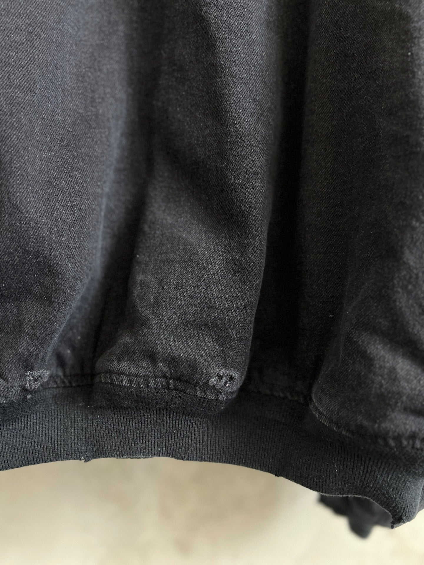 Balenciaga dark denim jacket hem with ribbed knit trim and stitching