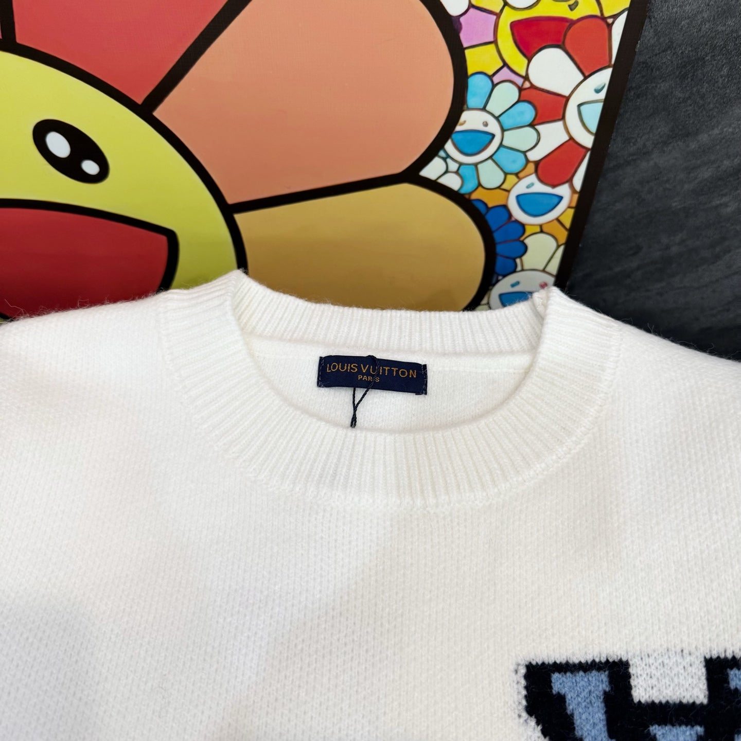 White knit long-sleeve sweatshirt with ribbed crew neck and small LV-style logo
