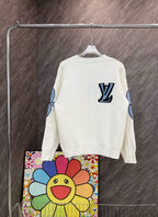 White long-sleeve knit sweatshirt with blue LV-style emblem on back and graphic sleeves