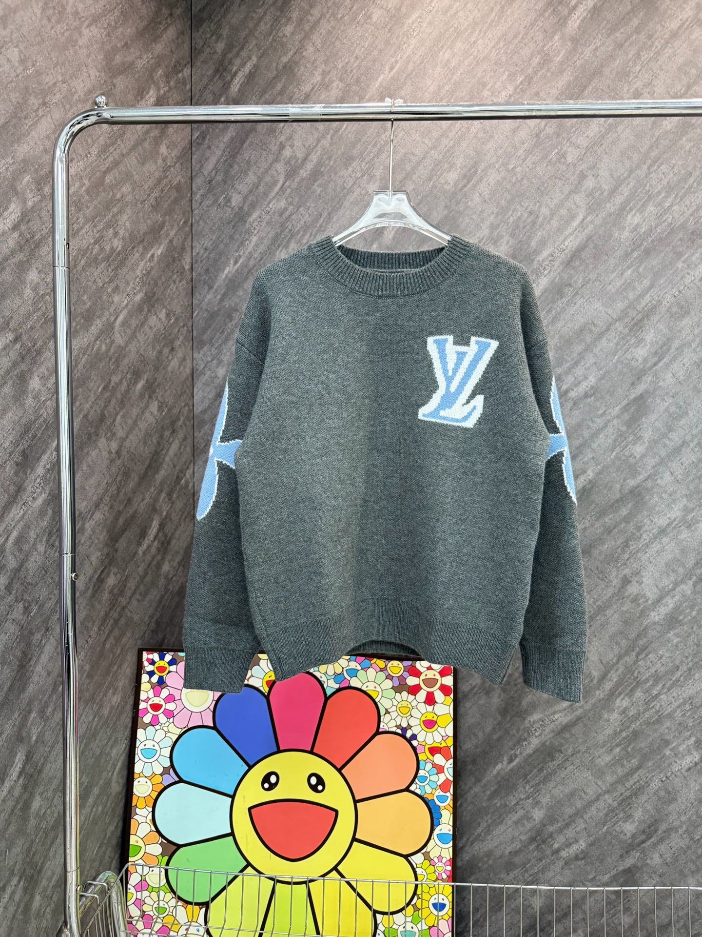Dark gray-green long-sleeve knit sweatshirt with blue LV-style emblem and graphic sleeves