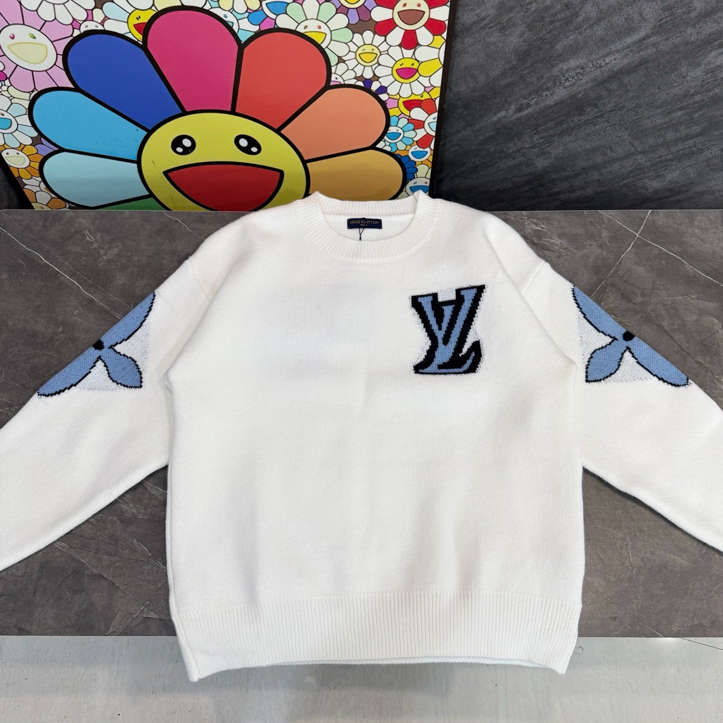 White knit sweater with Louis Vuitton blue monogram and playful sleeve motifs