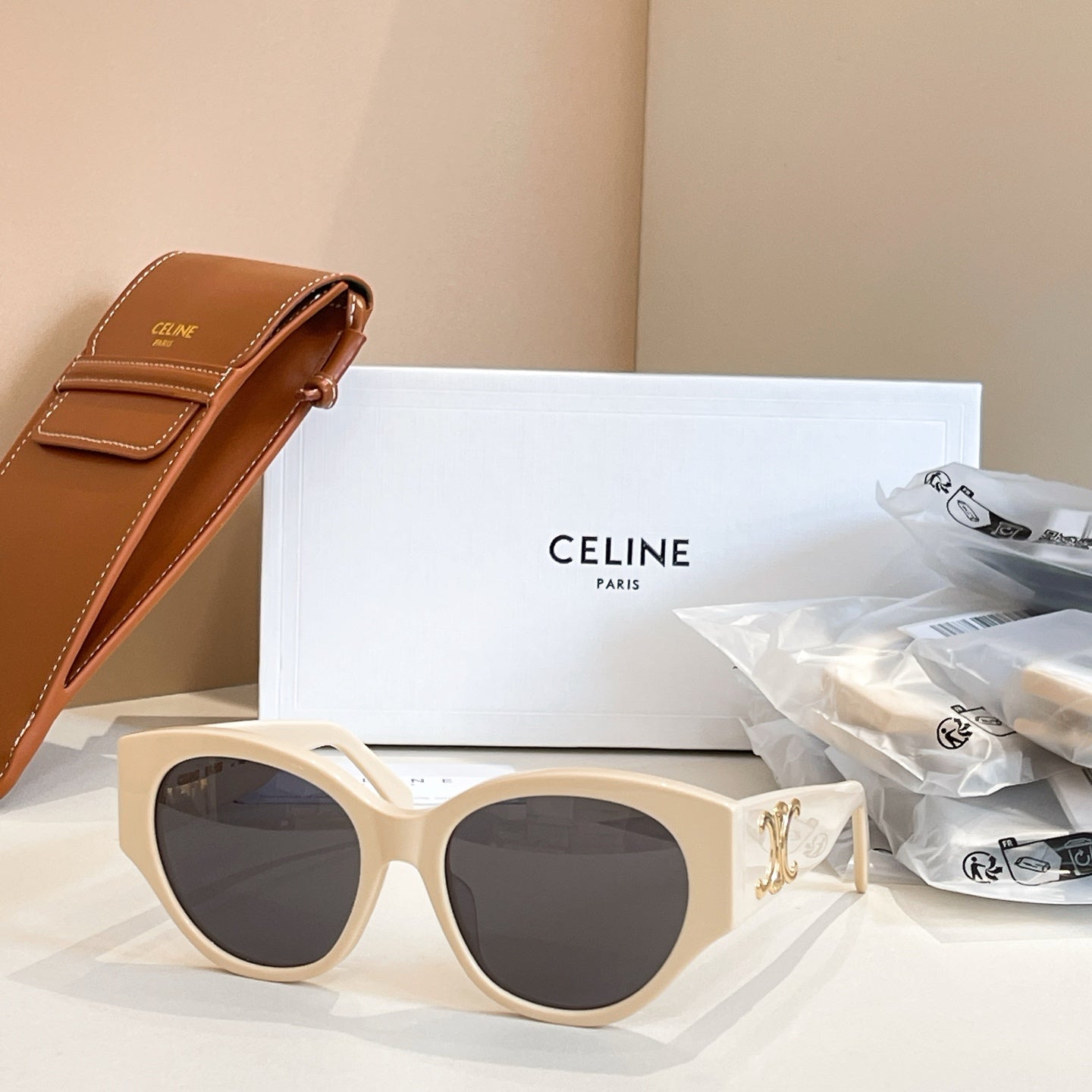 Celine sunglasses with cream frames and round lenses, gold logo detail