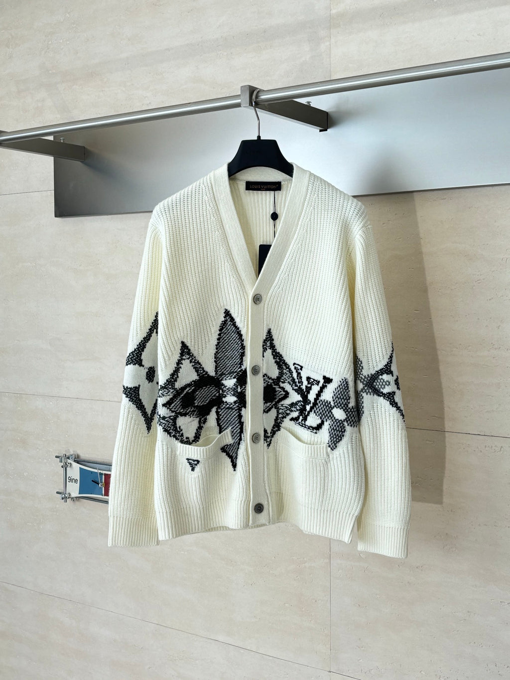 Ivory knit cardigan with black star-like graphic and button front
