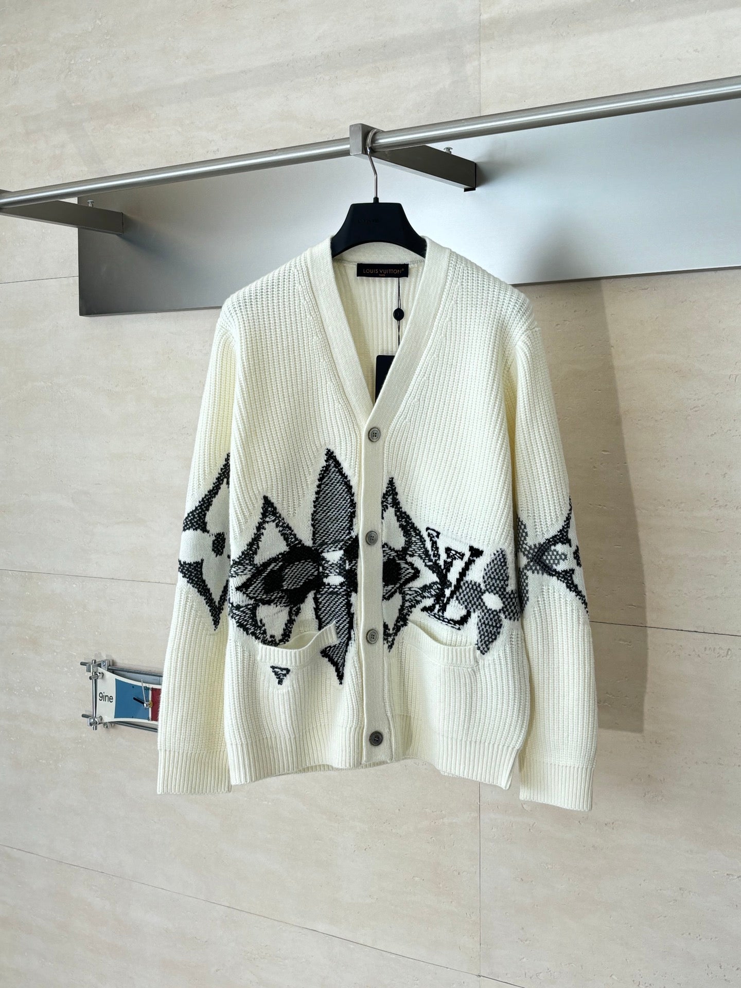 Ivory knit cardigan with black star-like graphic and button front