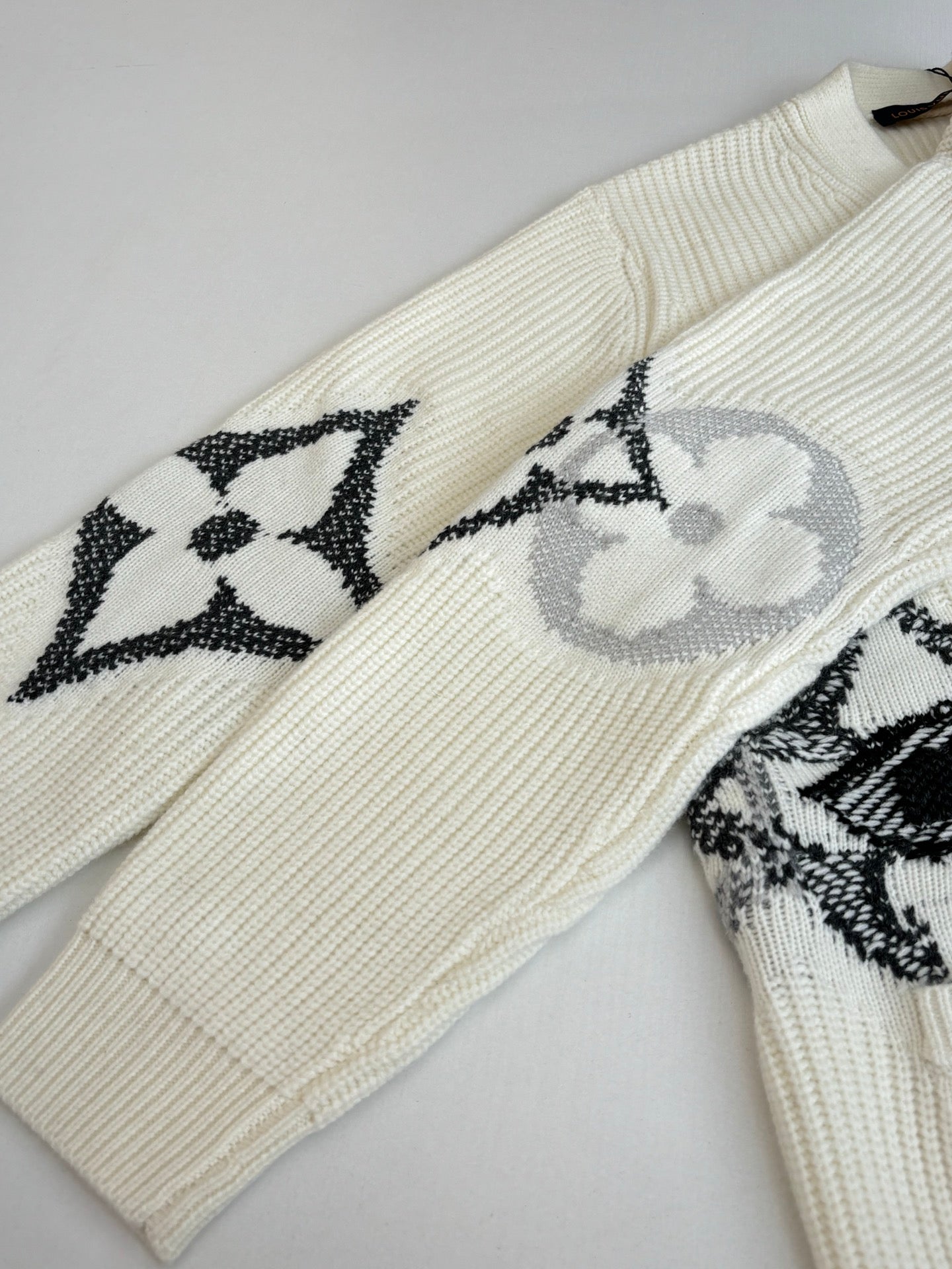 Cream knit sweater with long sleeves and black-and-white LV motif