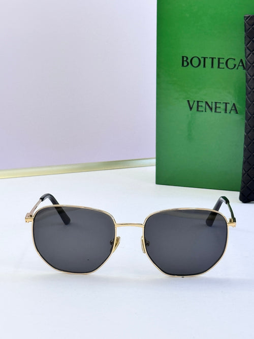 Gold-frame sunglasses with dark gray lenses and black temples