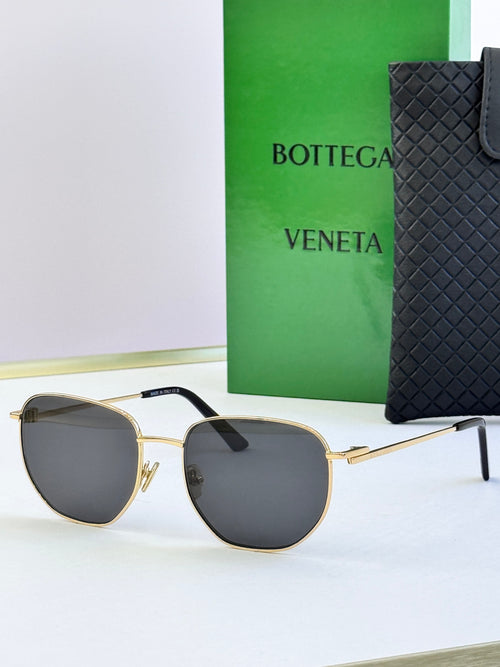 Gold-frame sunglasses with dark gray lenses and black temple tips