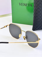 Gold-frame sunglasses with dark gray lenses, front view