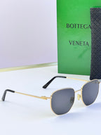 Gold-frame sunglasses with dark gray lenses and black temple arms