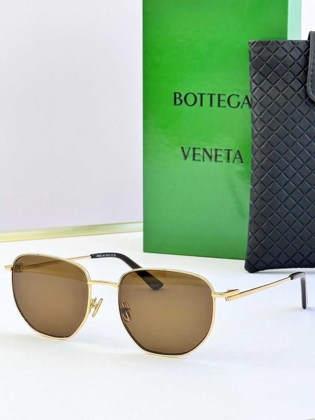 Gold-frame sunglasses with brown lenses and black temple detail