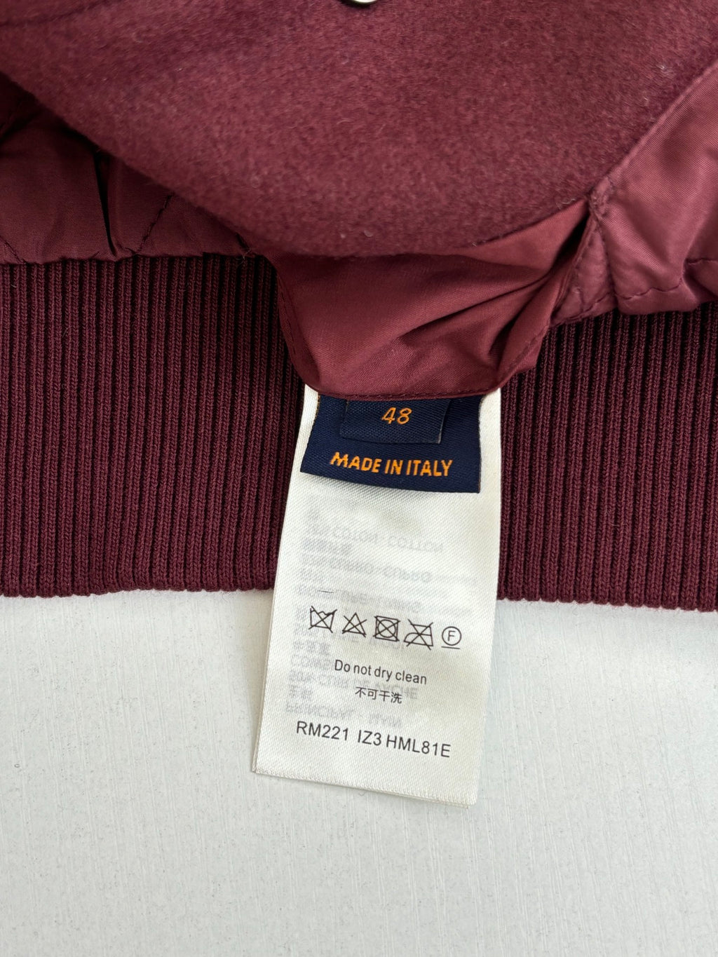 Burgundy ribbed cuff with interior care label: Made in Italy, RM221