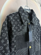 Dark denim jacket with monogram print, contrast panel, and snap buttons.