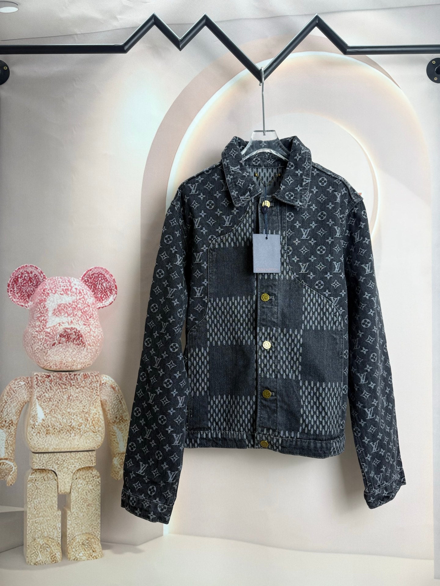 Dark denim jacket with repeating monogram print, button front, and stand collar.
