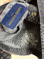 Denim jacket interior close-up with fabric tag reading "Louis Vuitton".
