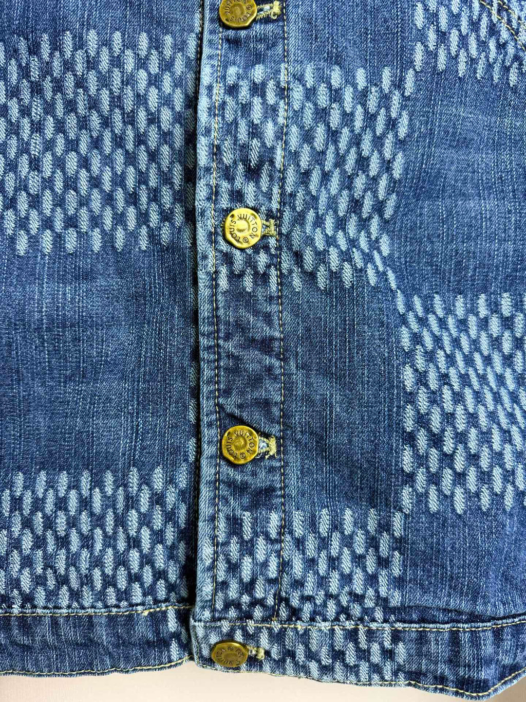 Blue denim jacket close-up of buttoned front and patterned yoke panels