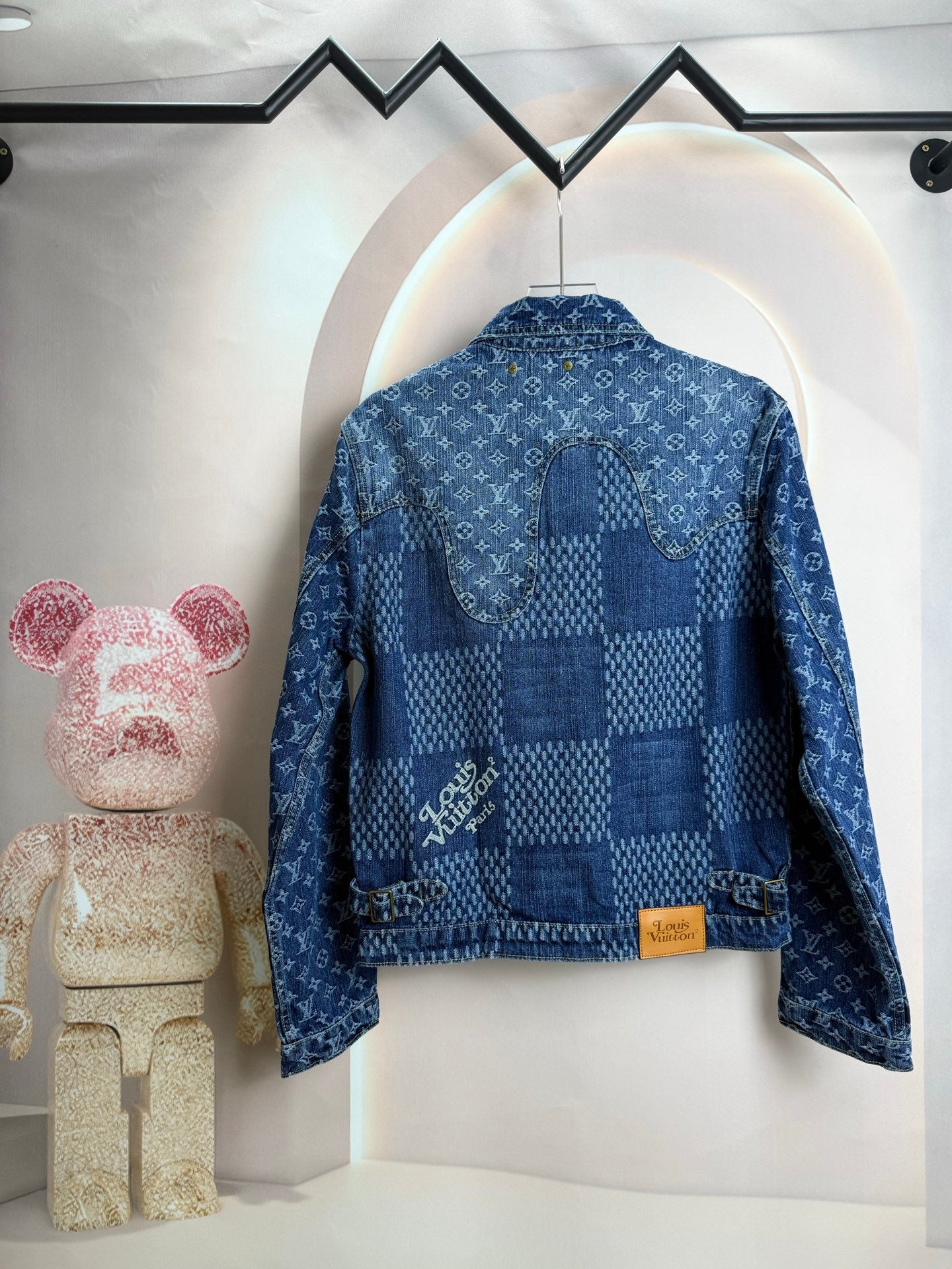 Blue denim jacket back view with curved yoke and gold buttons