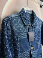 Blue denim jacket close-up with gold buttons on patch-style panel