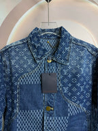 Blue denim jacket close-up showing collar, button placket, and logo pattern