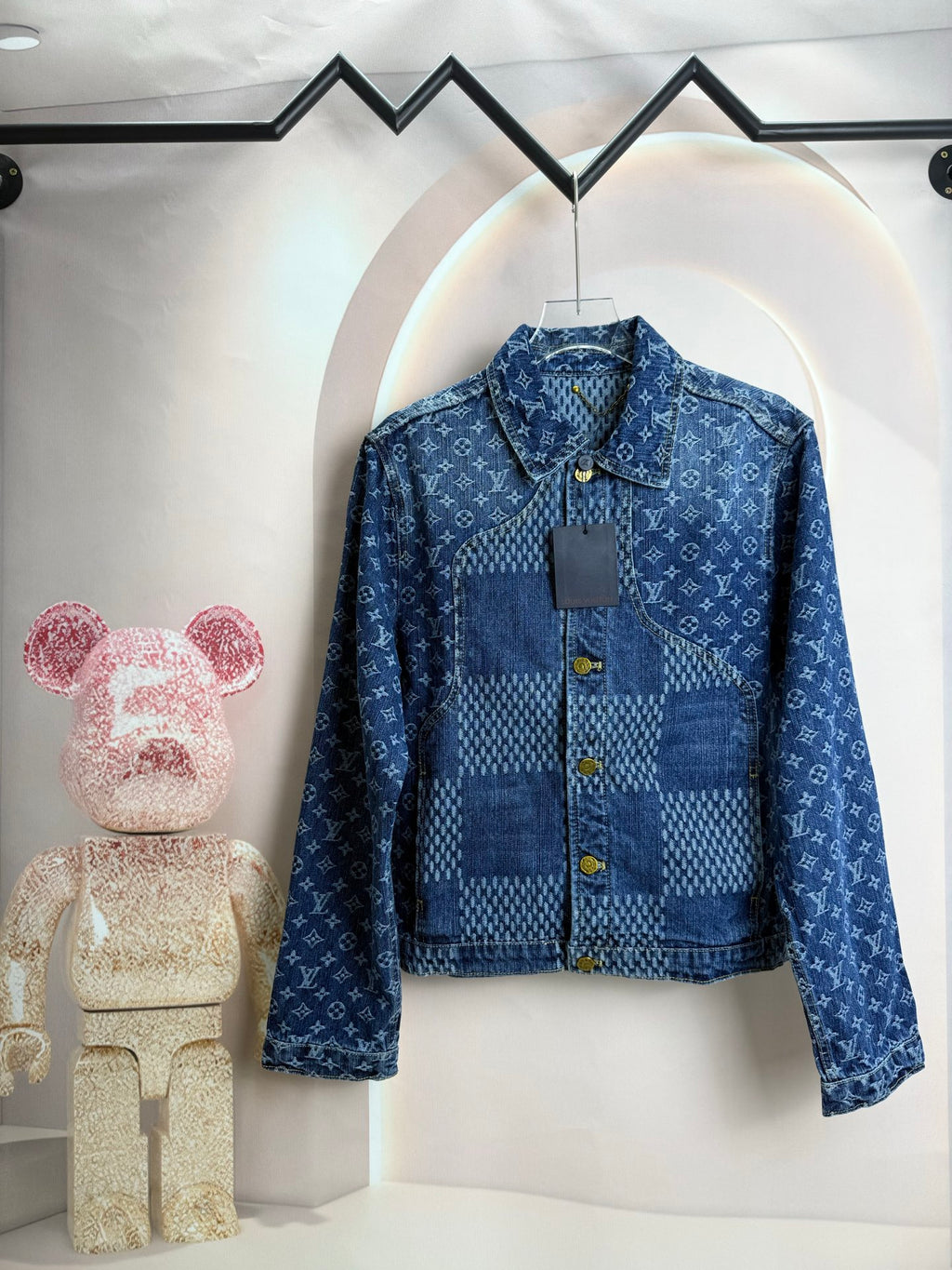 Blue denim jacket with raised collar and gold snap buttons on front