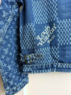 Blue denim jacket close-up of interior text label near button-tab detail