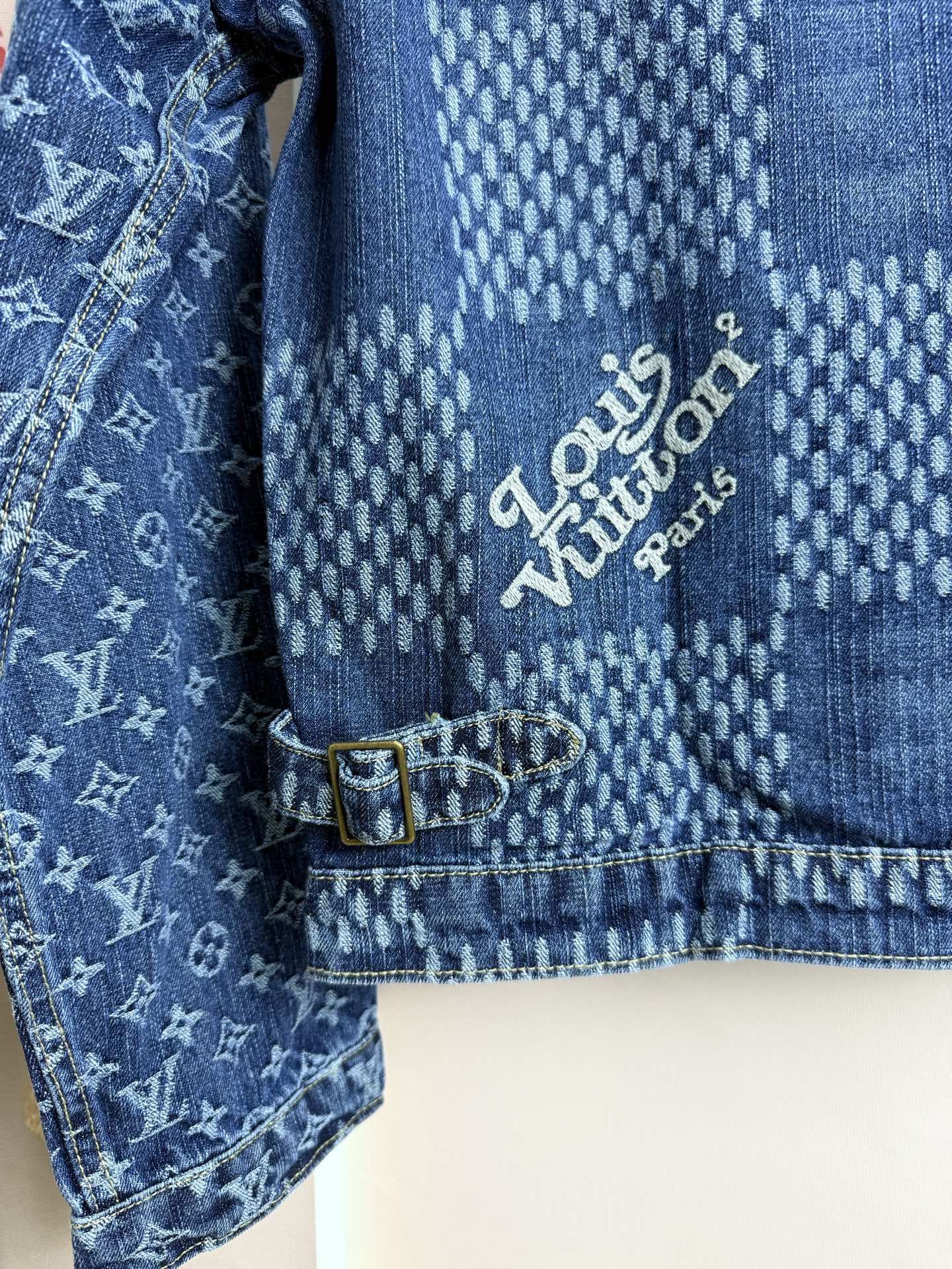 Blue denim jacket close-up of interior text label near button-tab detail